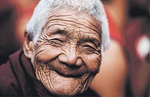 Smiling old woman long term travel image