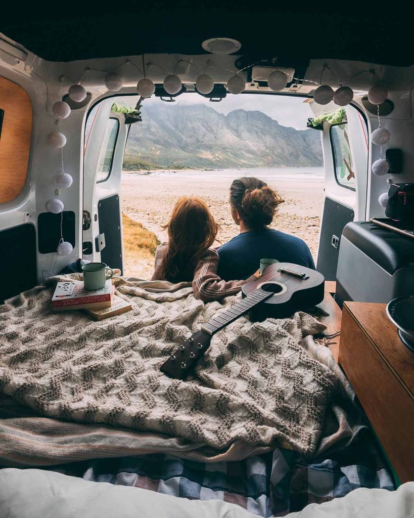 Van life couple in back of van